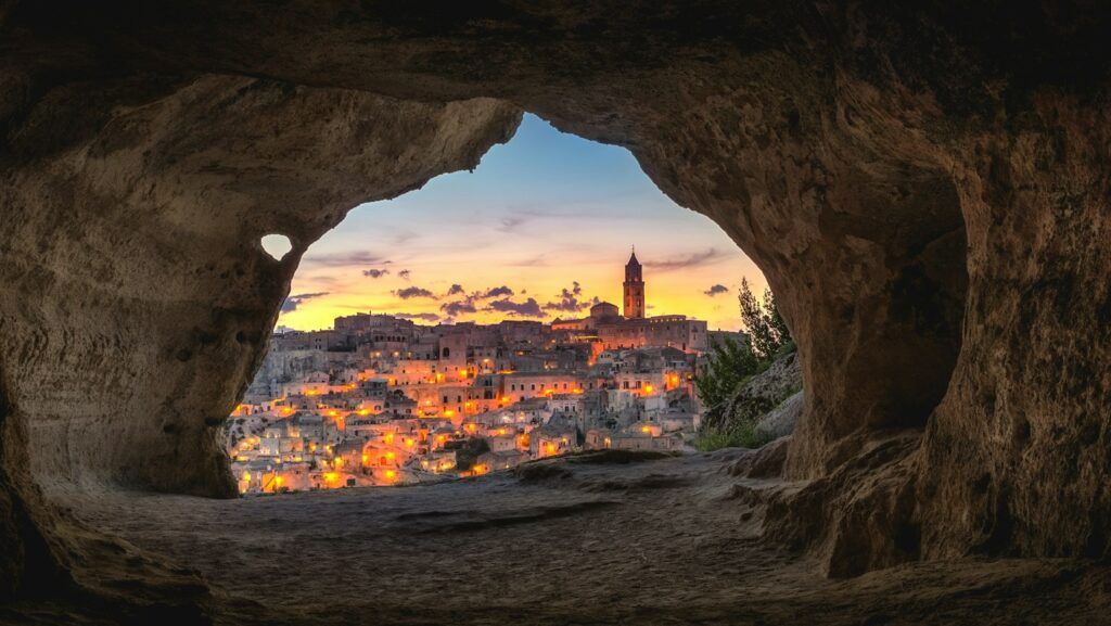 brown cave with over-view of city
